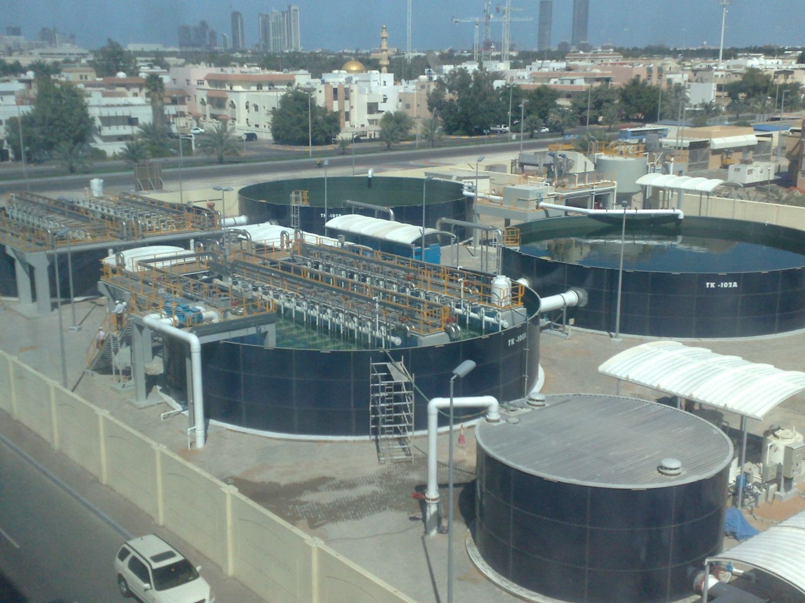 Aerial view of glass-fused-to-steel tanks and membrane bioreactor treatment trains at a sewage treatment plant in Abu Dhabi