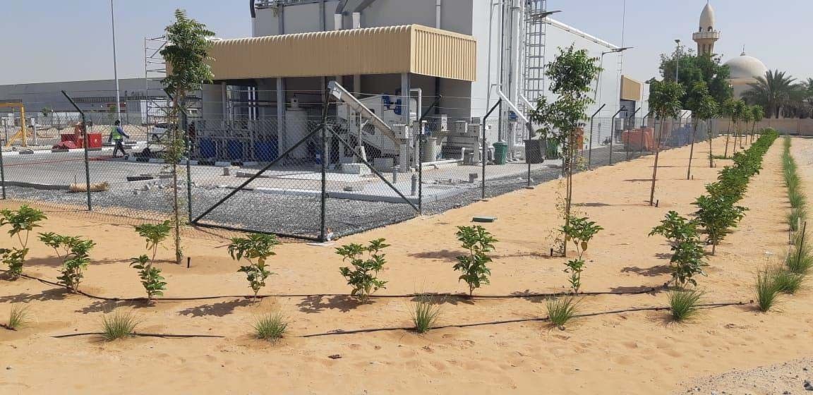 Landscaped grounds and young trees around the completed sewage treatment plant at Sharjah International Airport