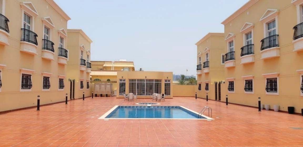 Shared swimming pool in the courtyard of the Nakhliyat villa development, Sharjah