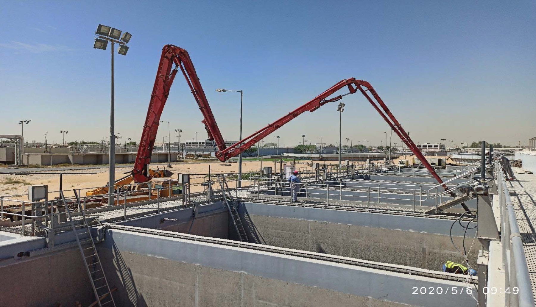 Concrete pump booms working over filter tanks during sand filter rehabilitation at Sharjah sewage treatment plant phase 7